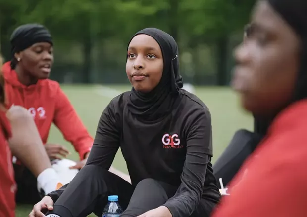 Goals 4 Girls players sitting together on a pitch after a session